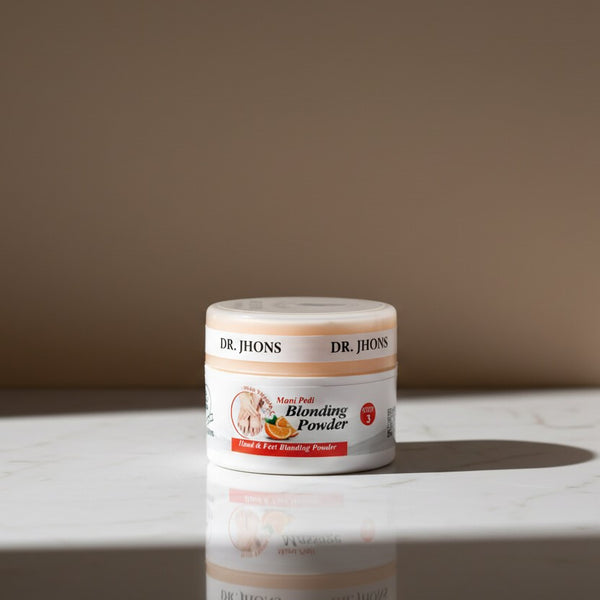 Jar of Dr. Jhons Blending Powder on a marble surface with a beige background